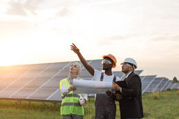 Three people discuss solar energy integration