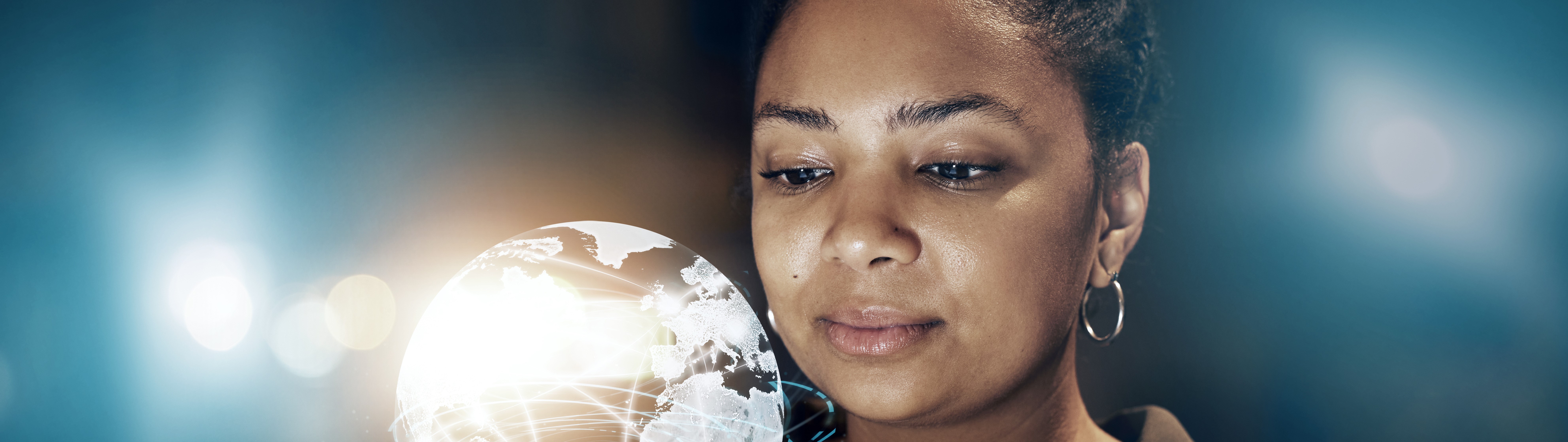 young black woman looking at transparent globe