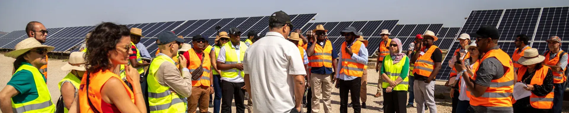 People gathered in front of solar panels