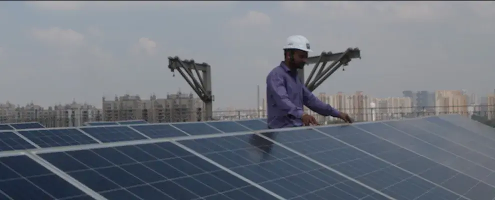 A man with solar panels on the roof
