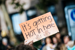 A placard reading “its getting hot in here”