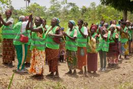 group of women standing on an untarred path within a bush